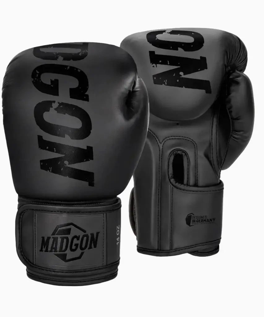 MADGON Boxhandschuhe in schwarz (14 OZ) auf weißem Hintergrund mit schwarzem Marken-Logo auf der Oberseite und am Handgelenk-Klettverschluss